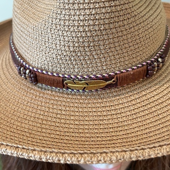 Cowboy hat. It’s tan with a gold shimmer